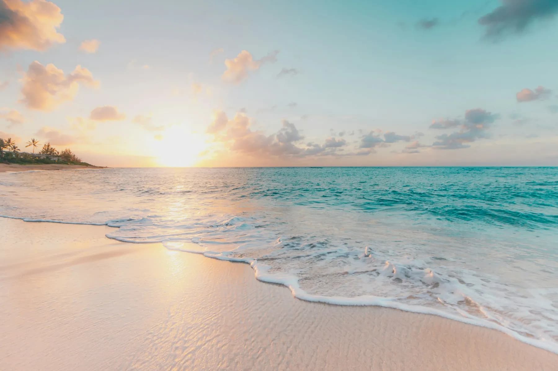 Blue ocean water meeting a bright shoreline